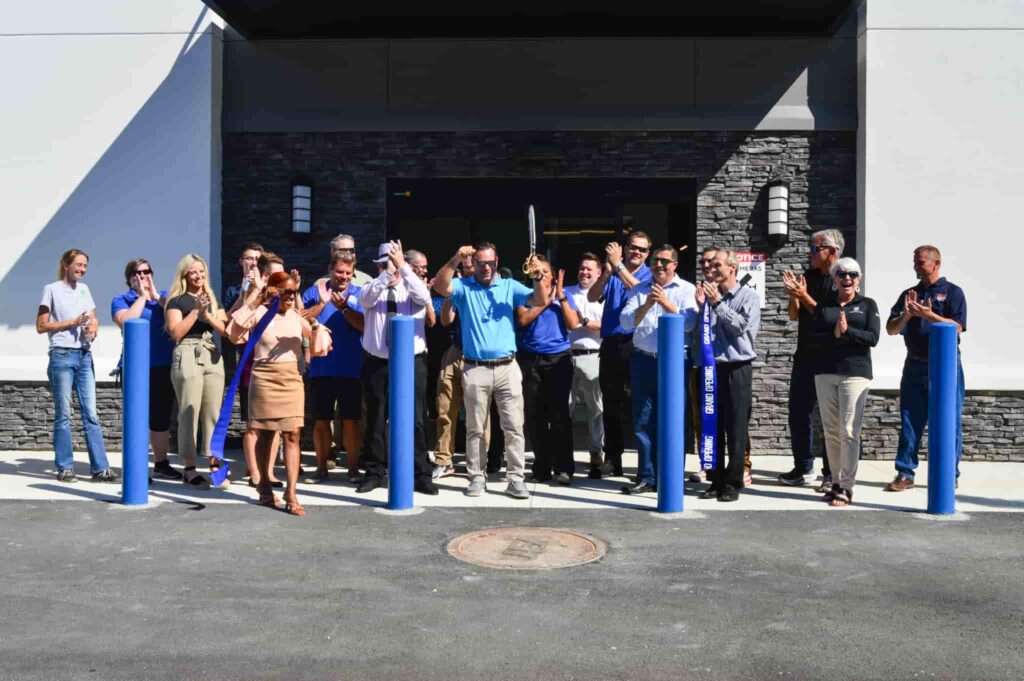 Atlantic team cheering while cutting ribbon at Regency Square location