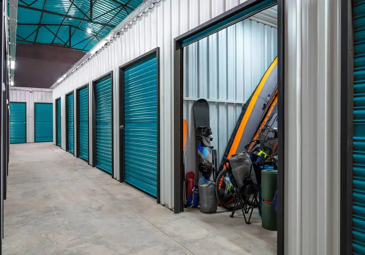 storage facility with an open storage unit displaying outdoor recreational items