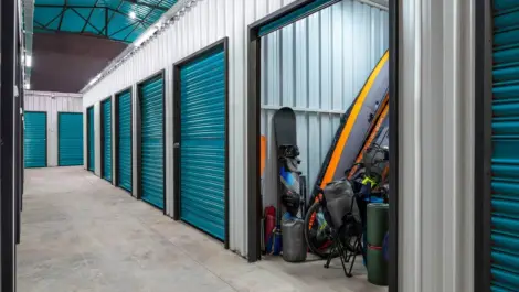 storage facility with an open storage unit displaying outdoor recreational items