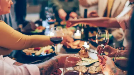 Blurred photo of people eating at table.